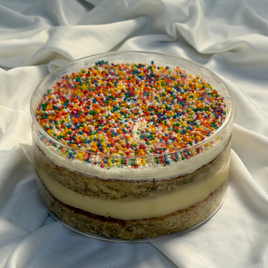 Dotcake with colorful sprinkles on a white fabric background