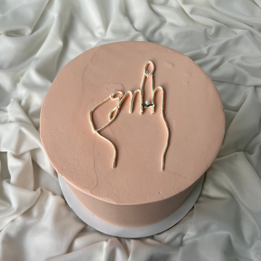 Round pink object with hand gesture design on a white fabric background