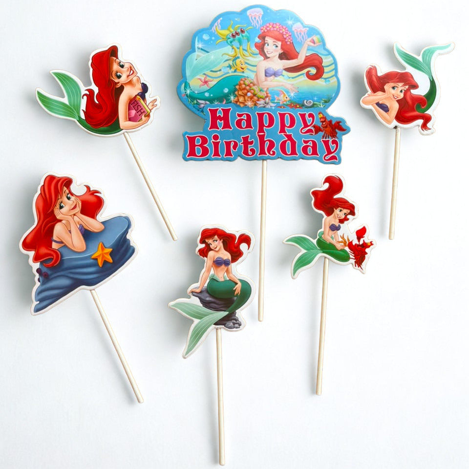 A set of Ariel-themed mermaid birthday cake toppers on wooden sticks, featuring various illustrations of Ariel and a central 'Happy Birthday' sign, displayed on a clean white background.