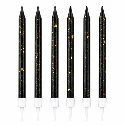 Set of six black candles with gold specks and white bases on a white background