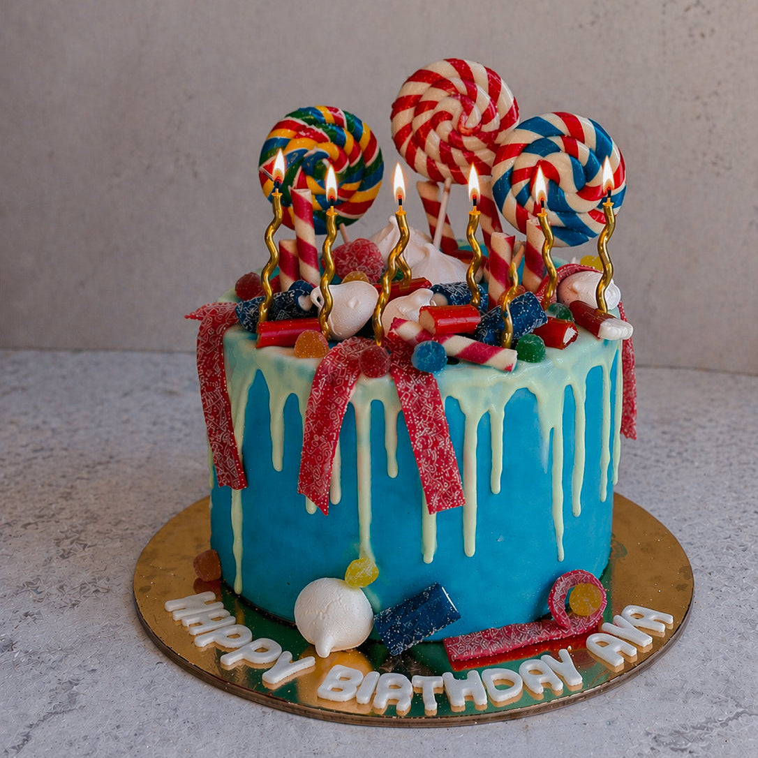 Colorful birthday cake with candles and candy decorations