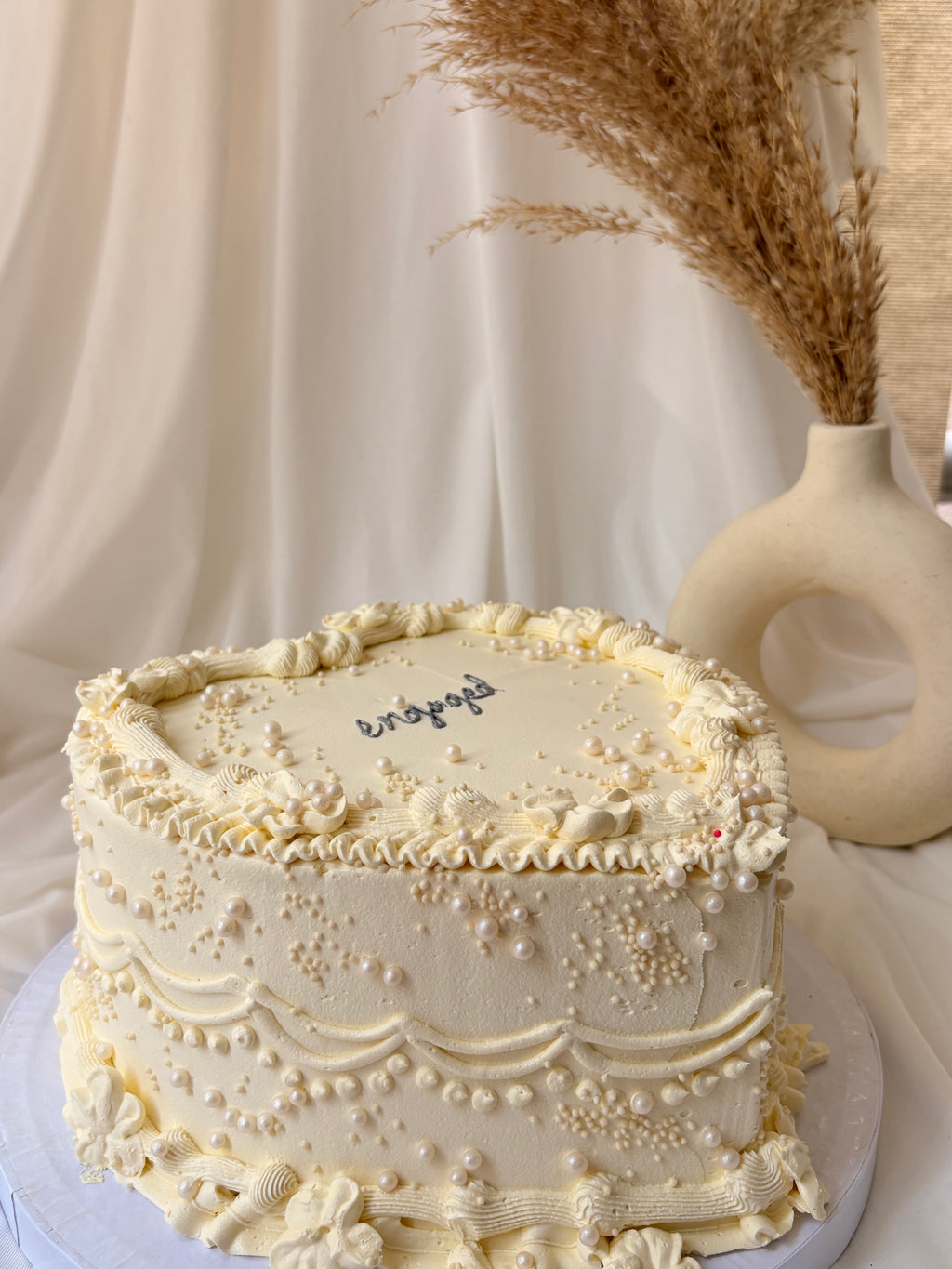 Decorative cake with intricate designs on a neutral background