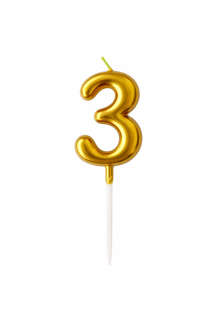 Gold number 3 candle on a white background