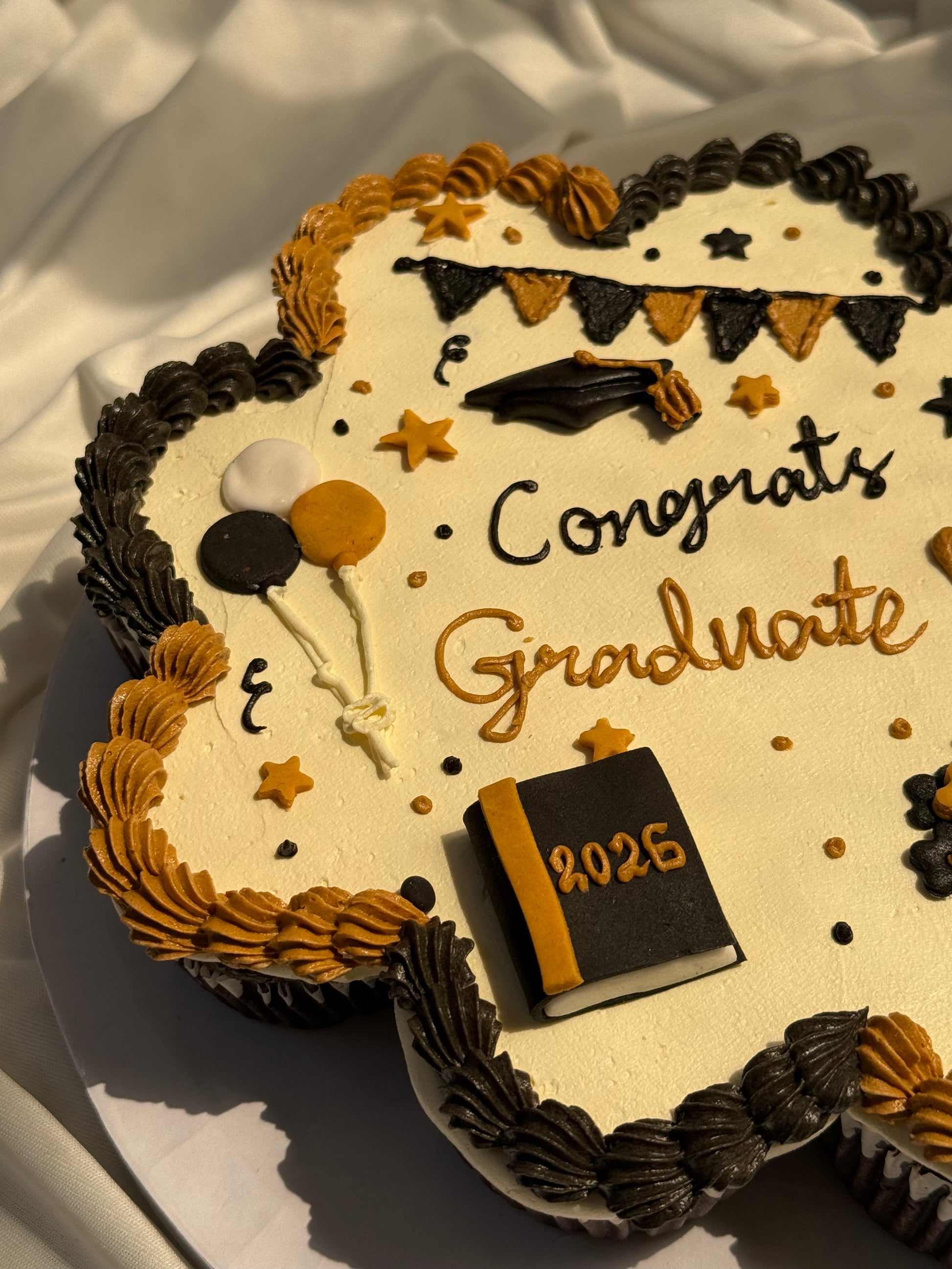 Celebrate graduation with a fun pull-apart cupcake cake made of 10 decorated cupcakes, perfect for sharing on the big day. 