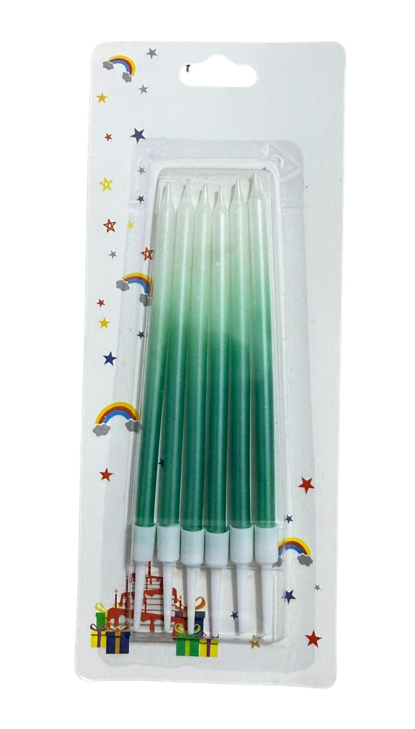 A set of ombre colored candles, with packaging that includes a pink and blue ombre design and a set of pink candles with a similar pattern.