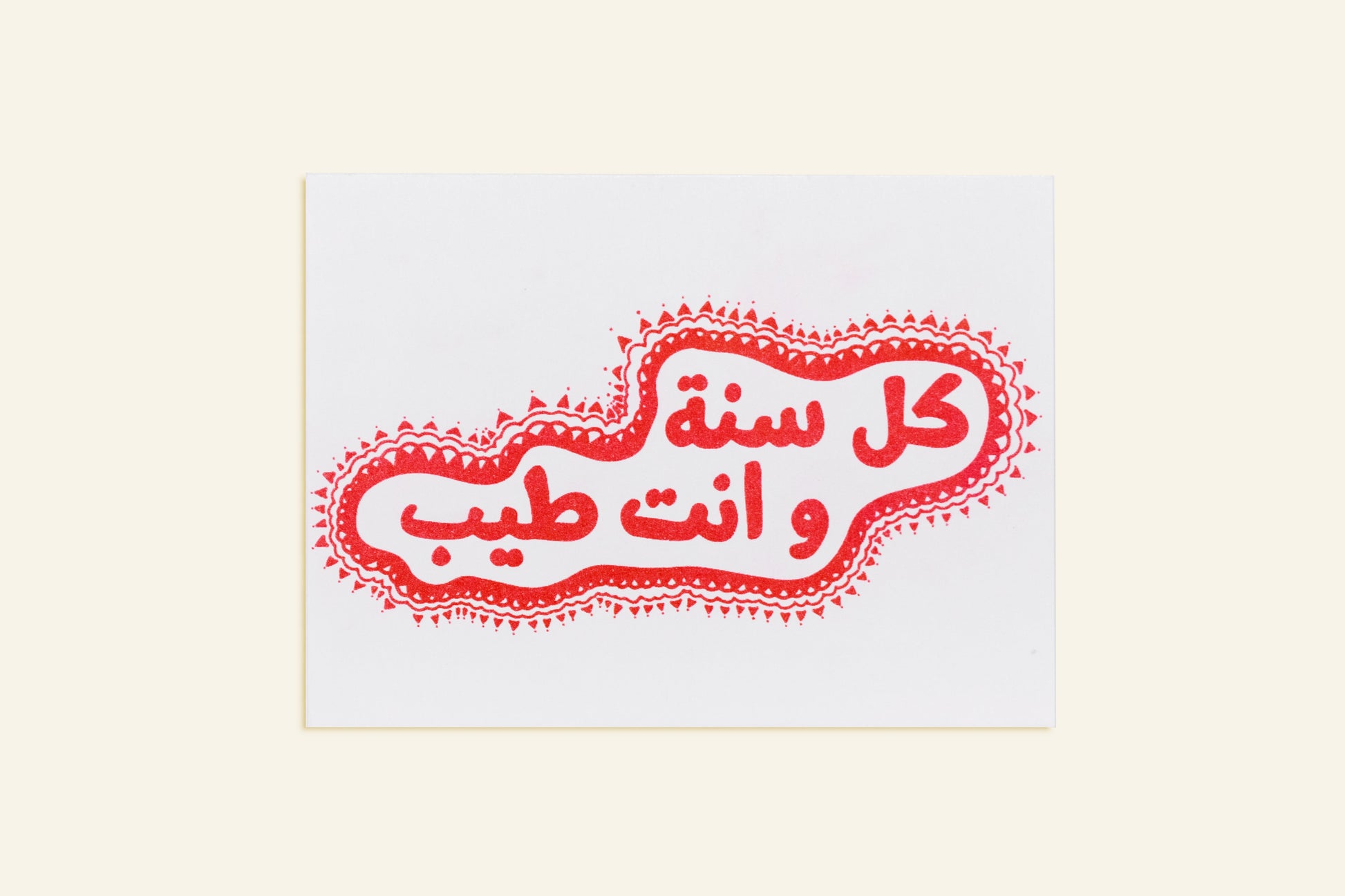 Decorative card with Arabic text and red design on a white background
