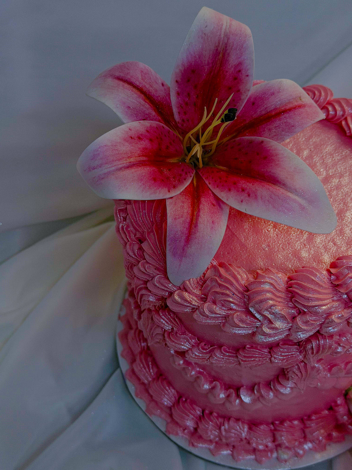 Pink cake with a large pink flower on top