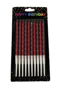 A pack of metallic burgundy birthday candles with white wax, presented in a clear plastic packaging with 'Happy Birthday' text and decorative glitter.