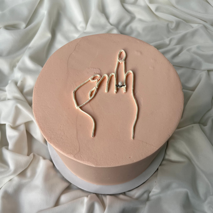 Round pink object with hand gesture design on a white fabric background