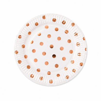 White paper plate with metallic rose gold polka dot design on white background