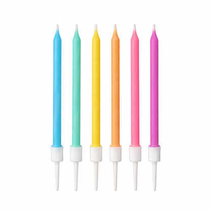Set of six colorful birthday candles on white sticks with white candle holders against a white background.