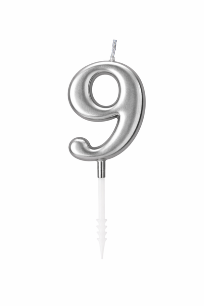 Silver number 9 candle on a white background