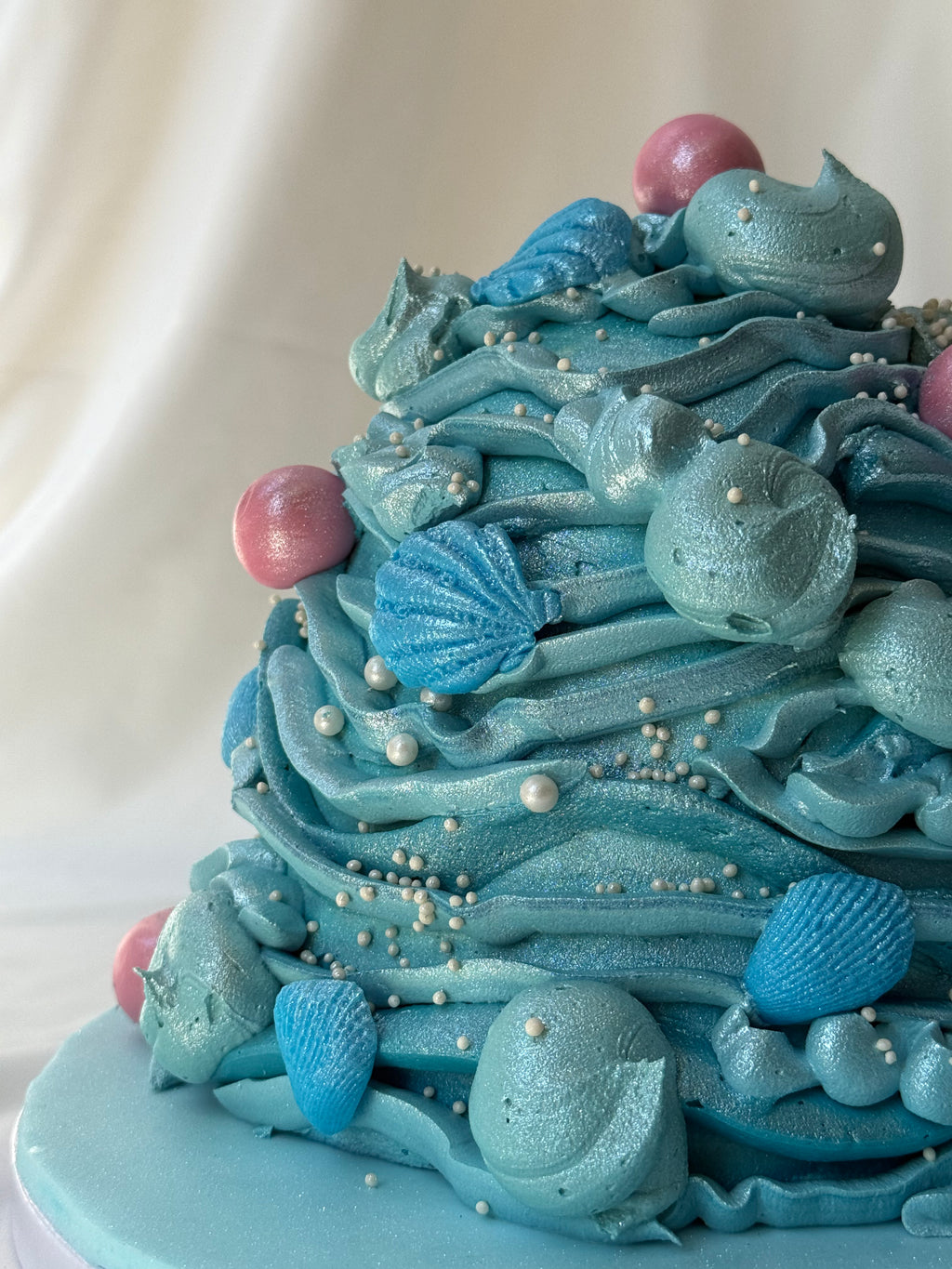 Blue cake with decorative elements on a white background