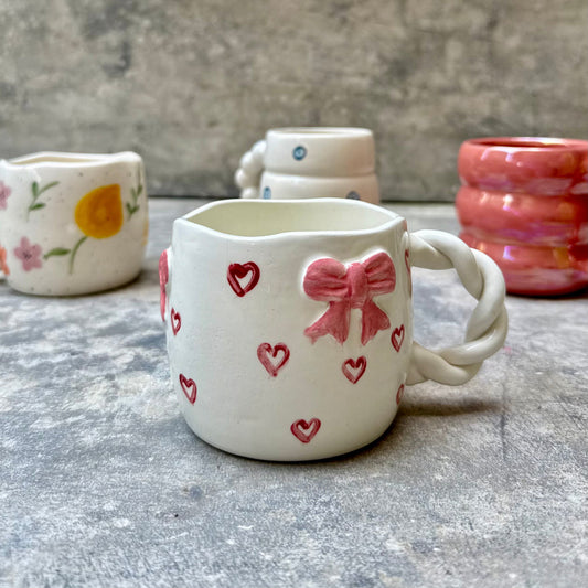 Sweetheart Sips mug with pink bow and red hearts