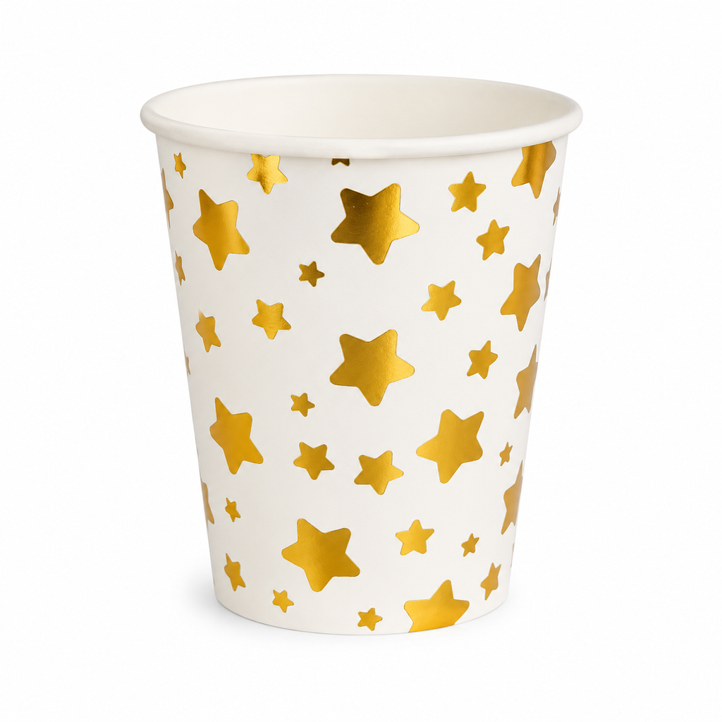 White paper cup with gold star pattern on a white background