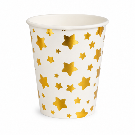 White paper cup with gold star pattern on a white background