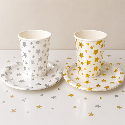 Two paper cups with star patterns on a matching saucer set against a white background.