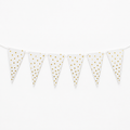 White bunting banner with gold metallic polka dots on triangular pennants, strung along a white cord against a plain white background.
