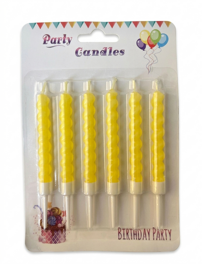 Pack of yellow birthday candles with decorative packaging on a white background