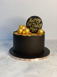 Man on Black and Gold Cake